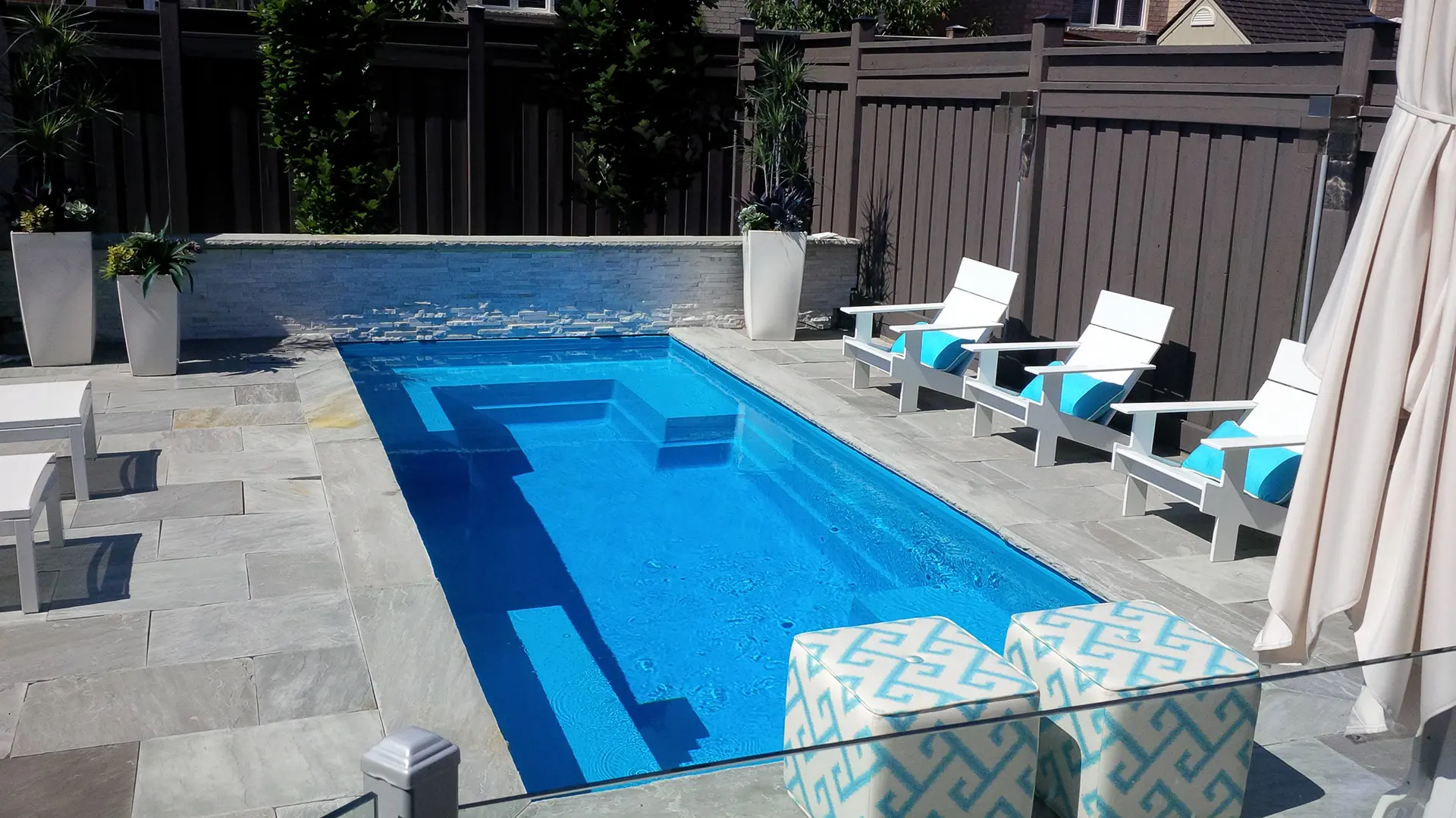 The Limitless rectangular fiberglass swimming pool with built-in spa and splash deck
